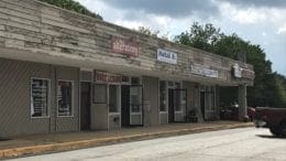 Sprayberry Crossing row of dilapidated storefronts -- there will be a hearing on redevelopment of the property