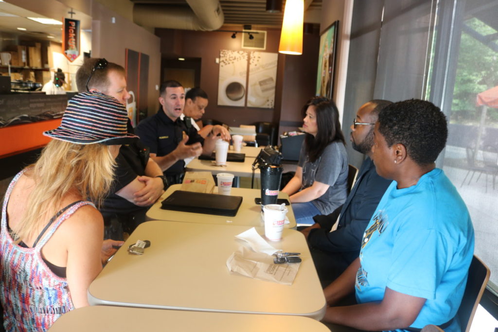 Officer Penirelli from Precinct 2 talks to Cobb residents at Coffee with a Cop (photo by Larry Felton Johnson)
