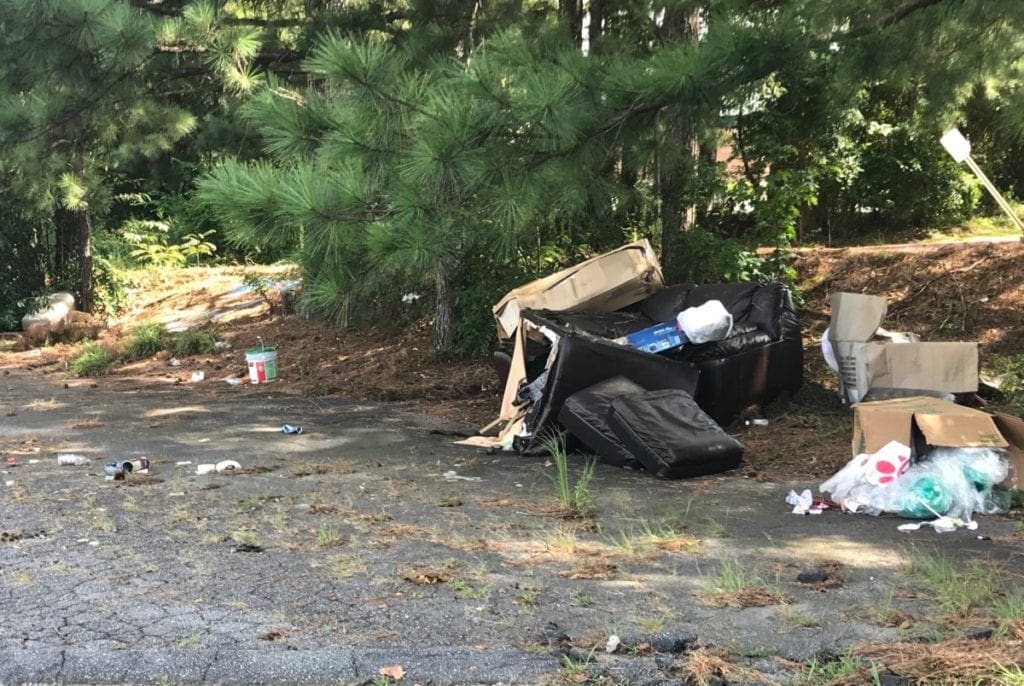 Bags of trash and other debris on Sprayberry Crossing property