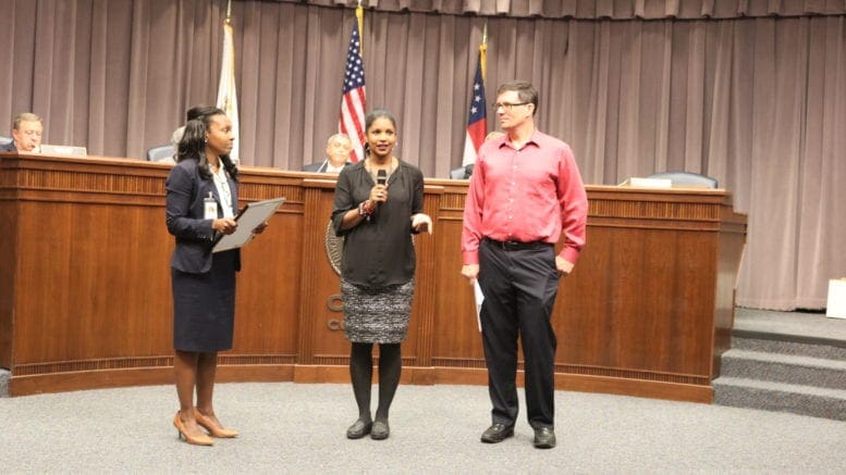 Commissioner Lisa Cupid, Ericka Smith, and Dr. Scott Hamilton at the Board of Commissioners meeting at the reading of the Dyslexia Awareness Month proclamation.