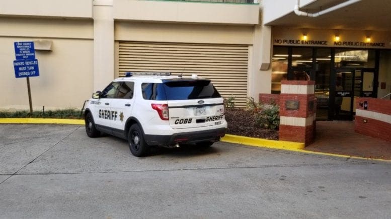 Cobb Sheriff's Office vehicle at Cobb government office in article about evictions