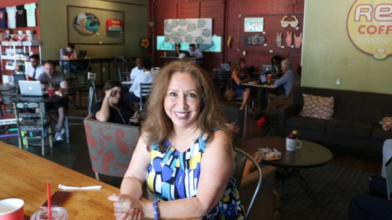 Laura Mireles seated at a table at Rev Coffee (photo by Larry Felton Johnson)