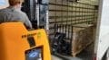 Forklift unloading pallets of Chromebooks for Cobb schools