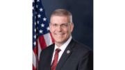 headshot of Representative Barry Loudermilk with flag behind his right shoulder