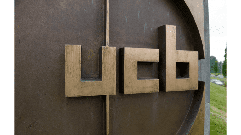 metal logo on signage outside a UCB building