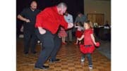 Man and little girl dress in Valentine colors dancing