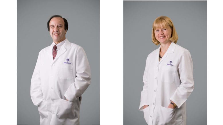 Dr. Mohamed Midani and Dr. Romualda Klicius in white medical coats, standing