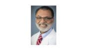 headshot photo of Dr. Arif Aziz wearing lab jacket with tie