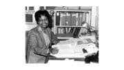 Gladys West at a desk smiling