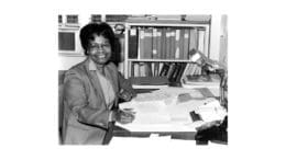 Gladys West at a desk smiling