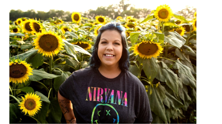 Angela Pence in a field of sunflowers