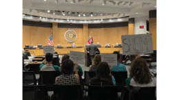 Dr. Mark Elgart addressed the Cobb School Board as members of Watching the Funds-Cobb held up signs expressing frustration over what they call a lack of financial transparency and questionable spending.