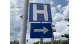 Hospital sign with a directional arrow