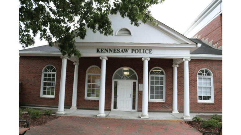 The brick Kennesaw Police Department building with 6 small columns on a portico