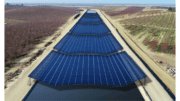 a grid of solar panels covering a canal
