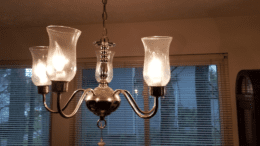 A light fixture with four glass covers and bulbs