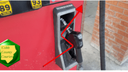 Gas pump with a Cobb County Courier logo and a jagged arrow pointed upward