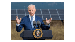 President Joseph Biden at a podium with solar panels in the background