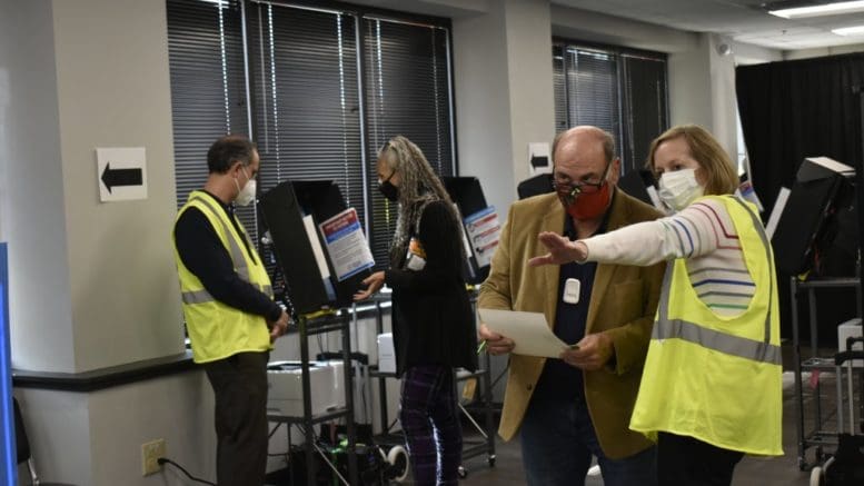 In Georgia, the Legislature gave the Georgia Bureau of Investigation authority to investigate election crimes and issue relevant subpoenas. Cobb County poll workers helped voters cast ballots in 2020. Ross Williams/Georgia Recorder