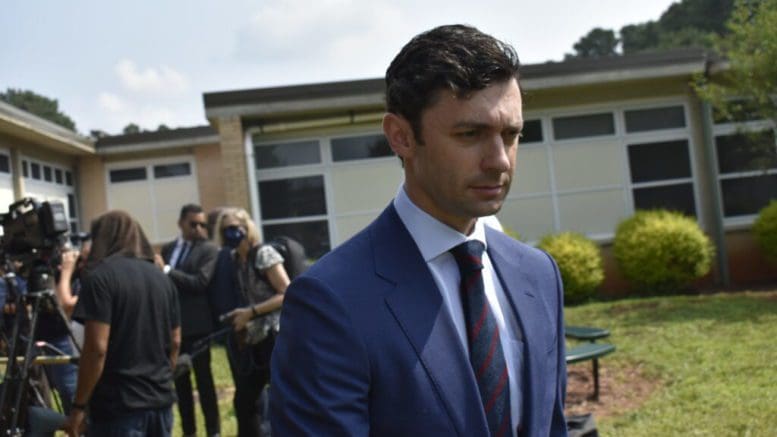 Jon Ossoff in suit walking away from group of people