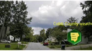 Cobb weather April 12: Photo of cloudy skies above a residential street