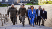 Nancy Pelosi walking up stairs with group of men