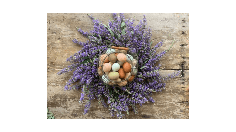 A bunch of colorful eggs surrounded by a spiral swirl of lavender stems and flowers