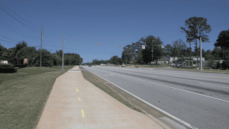 A wide cycling and pedestrian sidepath along a state highway.