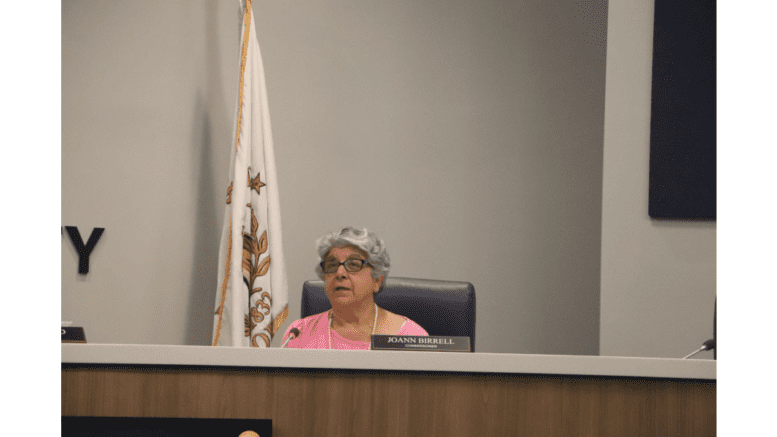 JoAnn Birrell on the dais at the Cobb Commissioners room.