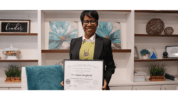 Commissioner Monique Sheffield holding certificate
