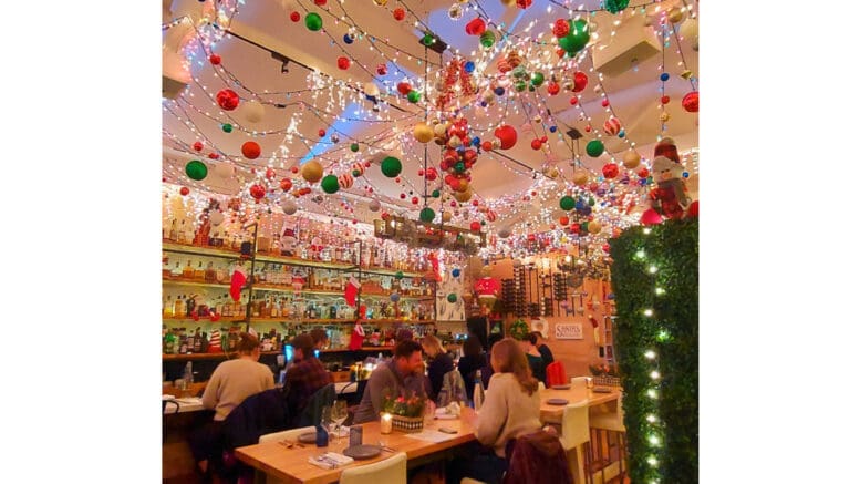 People at a table surrounded by holiday decorations