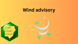 The title Wind Advisory with a drawing of leaves swirling in the wind alongside a Cobb County Courier logo