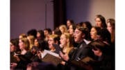 A diverse young group of college singers in concert