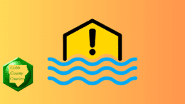 A flood watch or warning logo with a yellow house-shaped image, exclamation point in middle, blue wavy water lines below. A Cobb County Courier logo is in the lower left hand corner