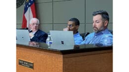 Trey Sinclair reading papers at Kennesaw City Council meeting