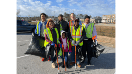 Group shot of people on a cleanup with green safety vests
