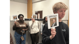 Four teens hold up signs with pictures of Chris Ragsdale and the word "opposed"