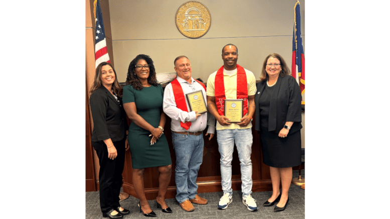 A group photo with two men getting certificates in the center. Three women Superior Court officials flank the men