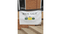 A sign for the Friends of Smyrna Library Summer Book Sale