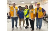 A group photo including three people in Lions Club vests