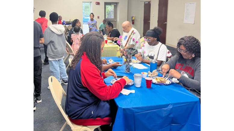 People of all ages sit at breakfast table